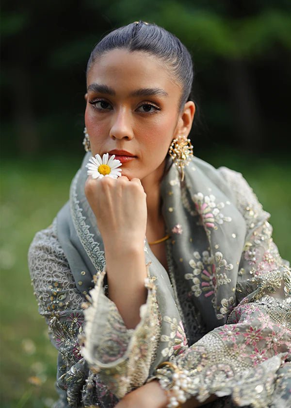 Model wearing a sage green Abshar dress from Suffuse FREESHIA RTW '24 Collection. Perfect for weddings, available online in the UK.