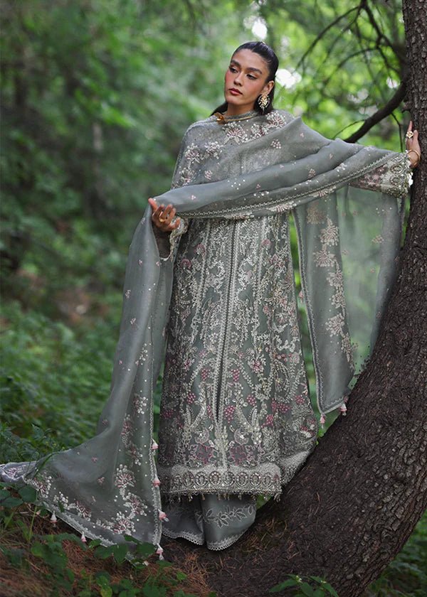 Model wearing a sage green Abshar dress from Suffuse FREESHIA RTW '24 Collection. Perfect for weddings, available online in the UK.