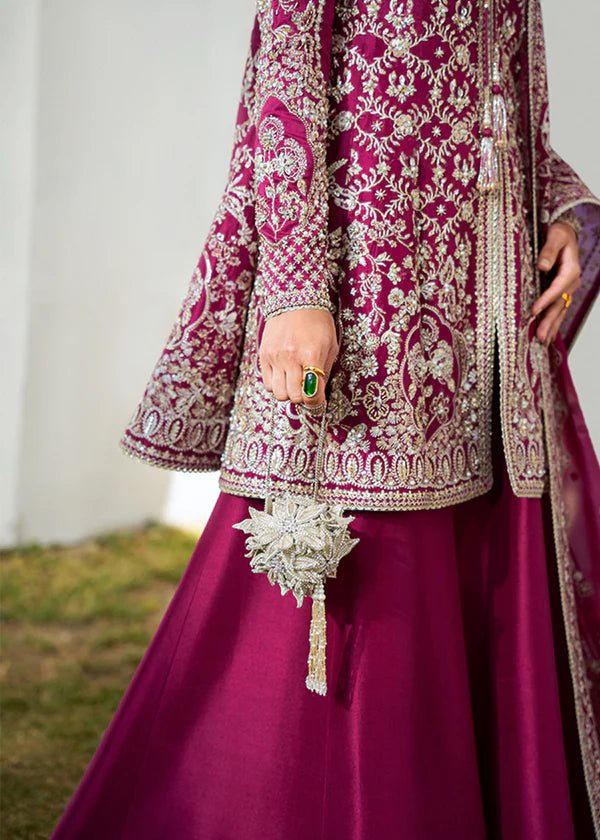 Model wearing a vibrant pink Ahlam dress from Suffuse's FREESHIA RTW '24 collection. Ideal for weddings, featuring intricate embroidery. Shop Pakistani clothes online in the UK.