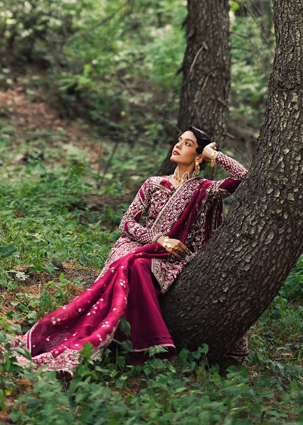 Model wearing a vibrant pink Ahlam dress from Suffuse's FREESHIA RTW '24 collection. Ideal for weddings, featuring intricate embroidery. Shop Pakistani clothes online in the UK.