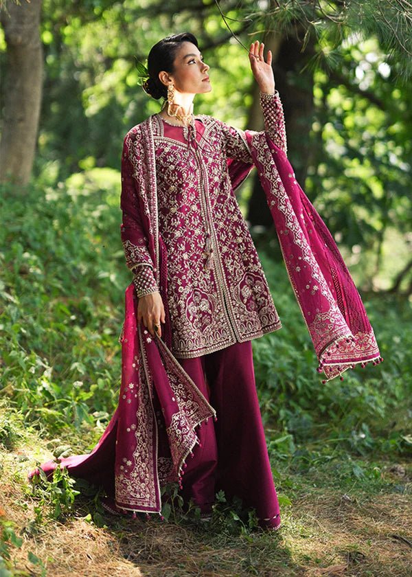 Model wearing a vibrant pink Ahlam dress from Suffuse's FREESHIA RTW '24 collection. Ideal for weddings, featuring intricate embroidery. Shop Pakistani clothes online in the UK.