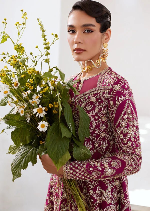 Model wearing a vibrant pink Ahlam dress from Suffuse's FREESHIA RTW '24 collection. Ideal for weddings, featuring intricate embroidery. Shop Pakistani clothes online in the UK.