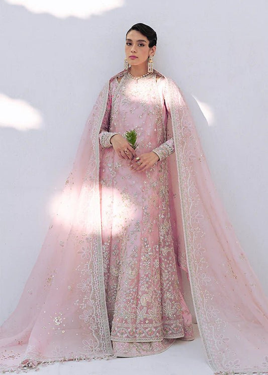 Model wearing Falek dress in blush pink from Suffuse's FREESHIA RTW '24. Ideal for Pakistani wedding clothes online in the UK.