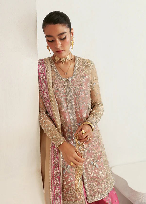 Model wearing pink and gold Hiraeth dress from Suffuse Freeshia RTW 2024 collection. Find Pakistani wedding clothes online in the UK