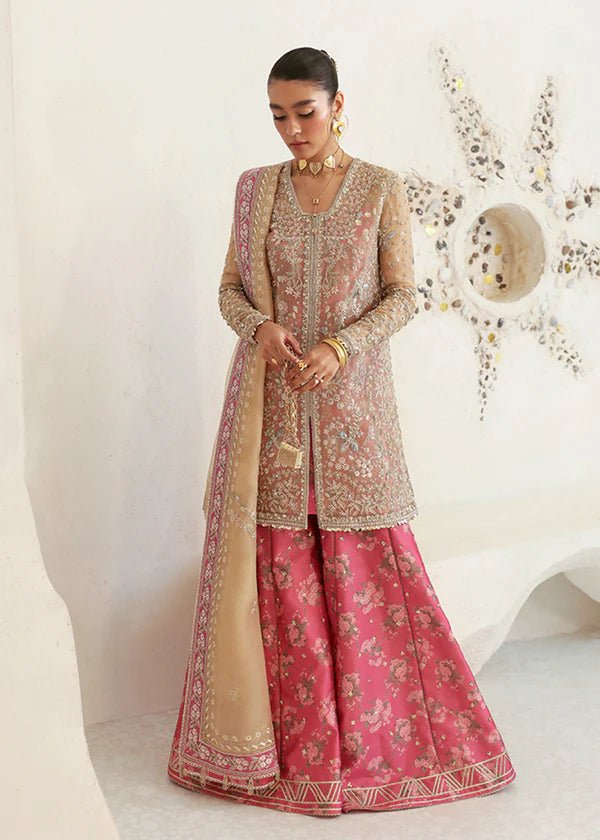 Model wearing pink and gold Hiraeth dress from Suffuse Freeshia RTW 2024 collection. Find Pakistani wedding clothes online in the UK