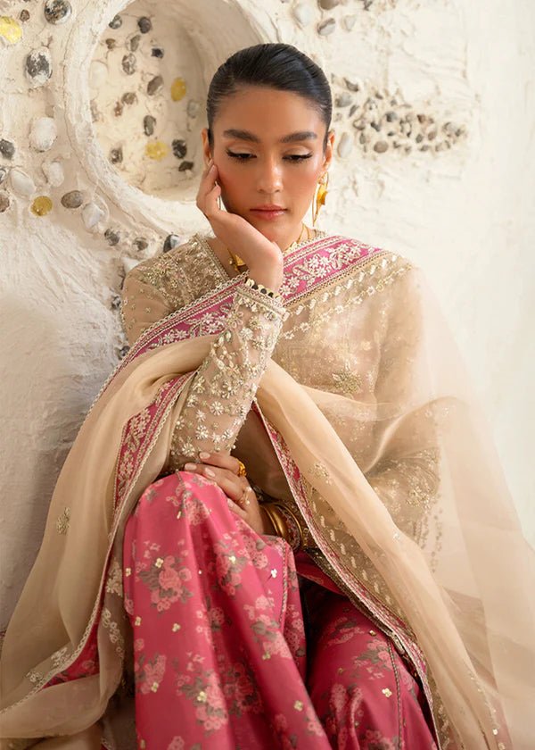 Model wearing pink and gold Hiraeth dress from Suffuse Freeshia RTW 2024 collection. Find Pakistani wedding clothes online in the UK