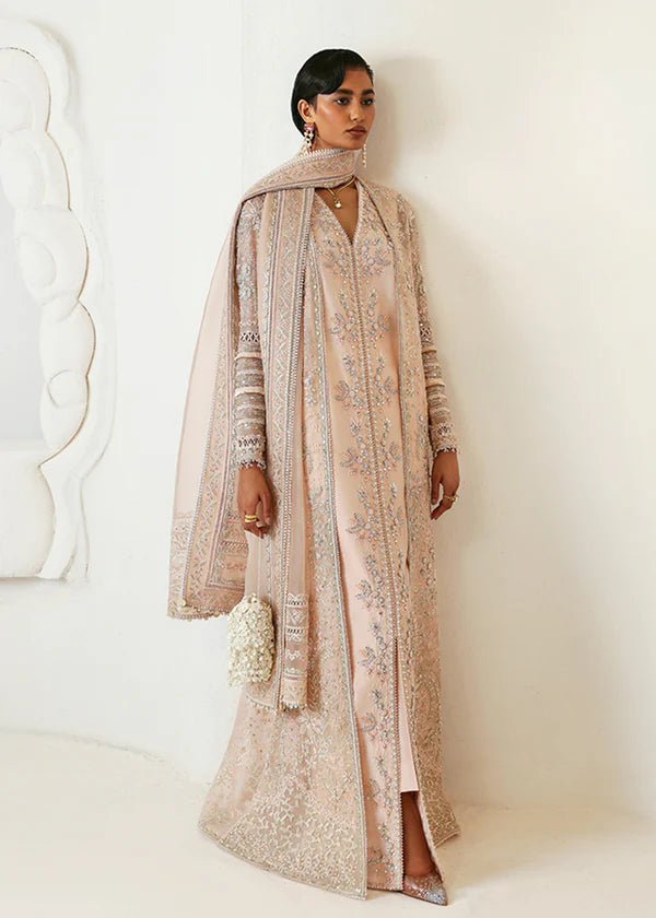 Model wearing a pale pink Janan dress from Suffuse, featuring intricate silver embroidery and matching dupatta. Perfect for Pakistani wedding clothes.