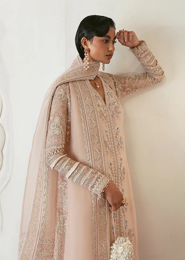 Model wearing a pale pink Janan dress from Suffuse, featuring intricate silver embroidery and matching dupatta. Perfect for Pakistani wedding clothes.