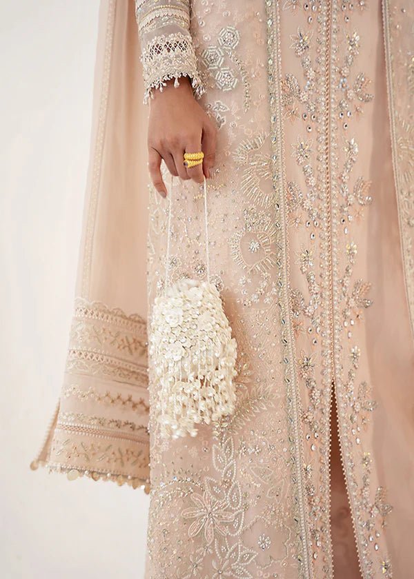 Model wearing a pale pink Janan dress from Suffuse, featuring intricate silver embroidery and matching dupatta. Perfect for Pakistani wedding clothes.