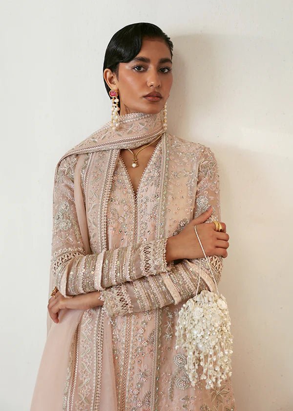 Model wearing a pale pink Janan dress from Suffuse, featuring intricate silver embroidery and matching dupatta. Perfect for Pakistani wedding clothes.