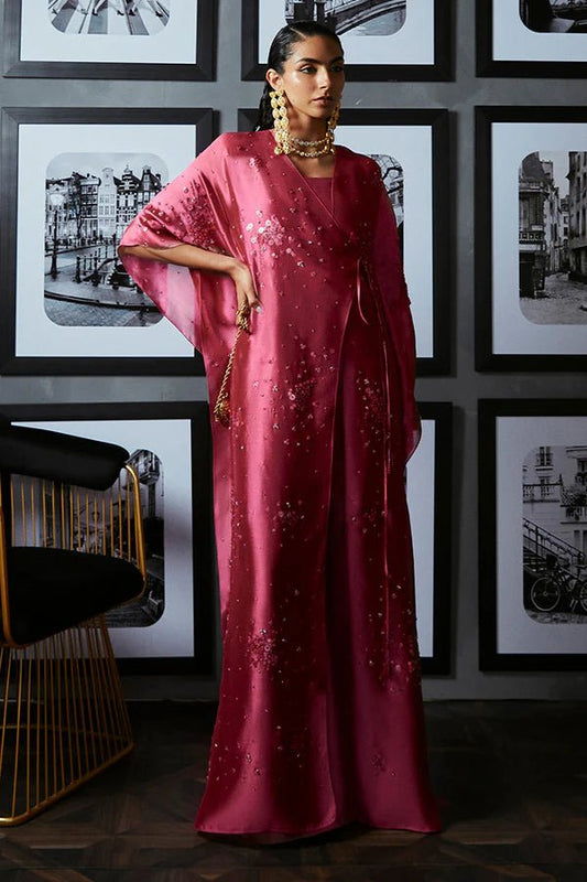 Model in Suffuse Ilsa dress, vibrant pink with sequin details, luxe Pakistani UK attire.