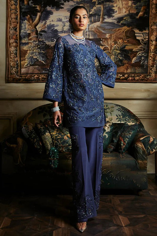 Model in navy blue Irina dress by Suffuse, epitome of Pakistani luxury pret in the UK.