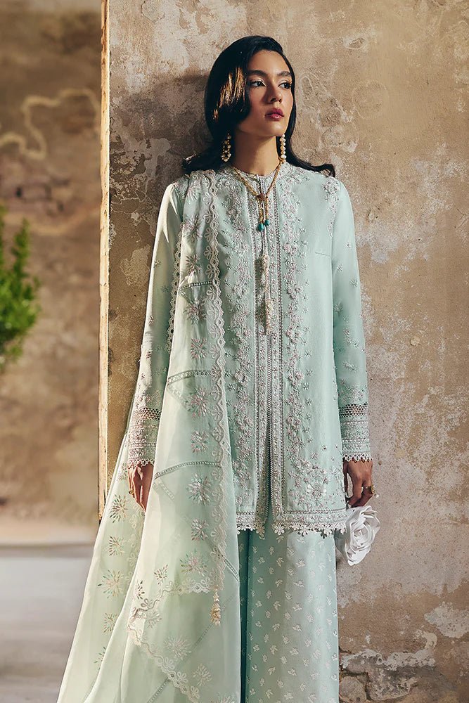 Model wearing Suffuse Silk Pret '24 Gale dress in pastel green with delicate embroidery and embellishments. Shop Pakistani bridal dresses online in the UK now.