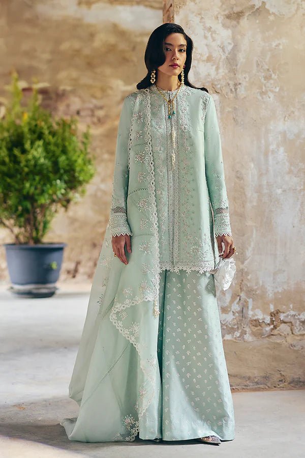 Model wearing Suffuse Silk Pret '24 Gale dress in pastel green with delicate embroidery and embellishments. Shop Pakistani bridal dresses online in the UK now.