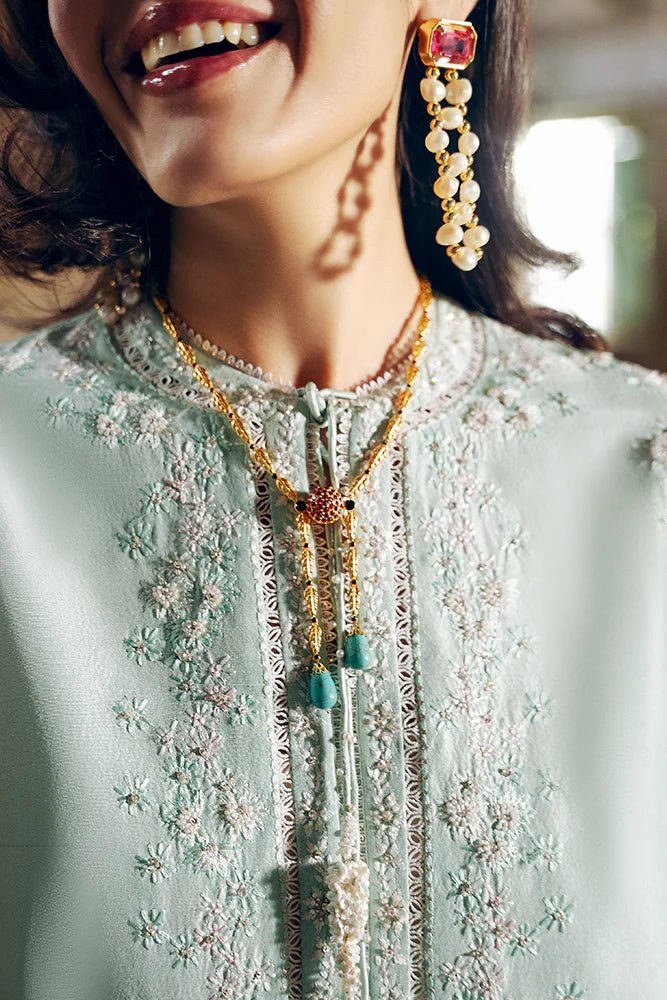 Model wearing Suffuse Silk Pret '24 Gale dress in pastel green with delicate embroidery and embellishments. Shop Pakistani bridal dresses online in the UK now.