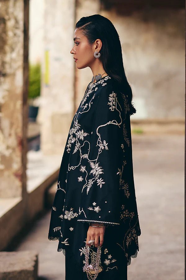 Model wearing black Illiae dress from Suffuse, featuring intricate silver embroidery, perfect for Pakistani Eid clothes in the UK.