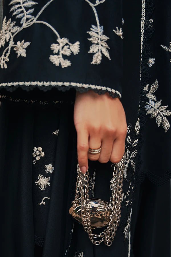 Model wearing black Illiae dress from Suffuse, featuring intricate silver embroidery, perfect for Pakistani Eid clothes in the UK.