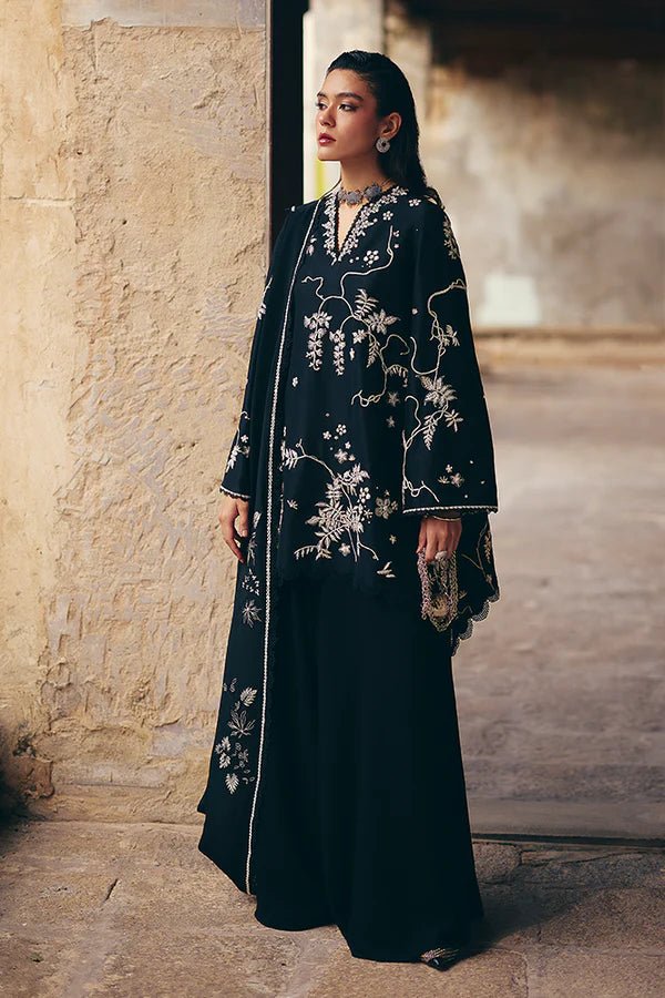 Model wearing black Illiae dress from Suffuse, featuring intricate silver embroidery, perfect for Pakistani Eid clothes in the UK.