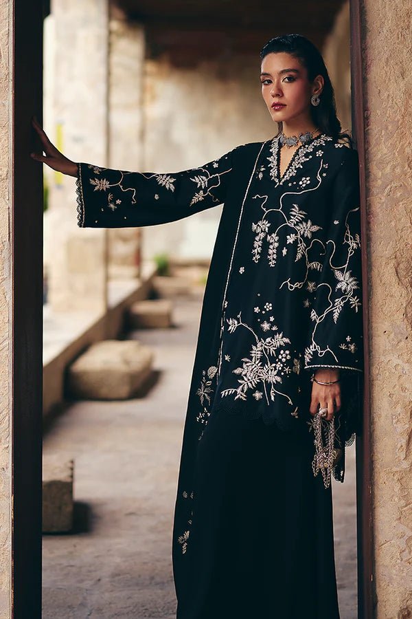 Model wearing black Illiae dress from Suffuse, featuring intricate silver embroidery, perfect for Pakistani Eid clothes in the UK.