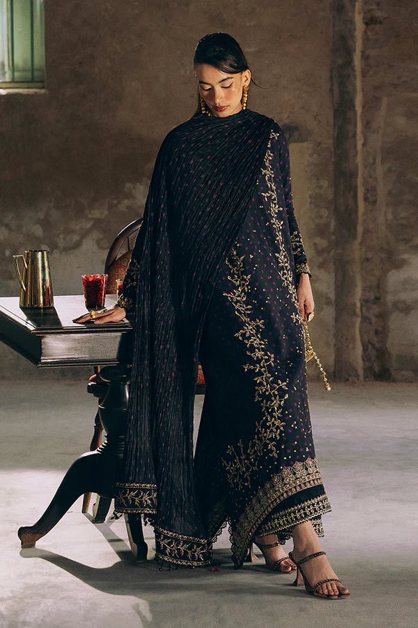 Model wearing Suffuse Silk Pret '24 Layale dress in deep black with intricate gold embroidery. Shop Pakistani bridal dresses online in the UK now.