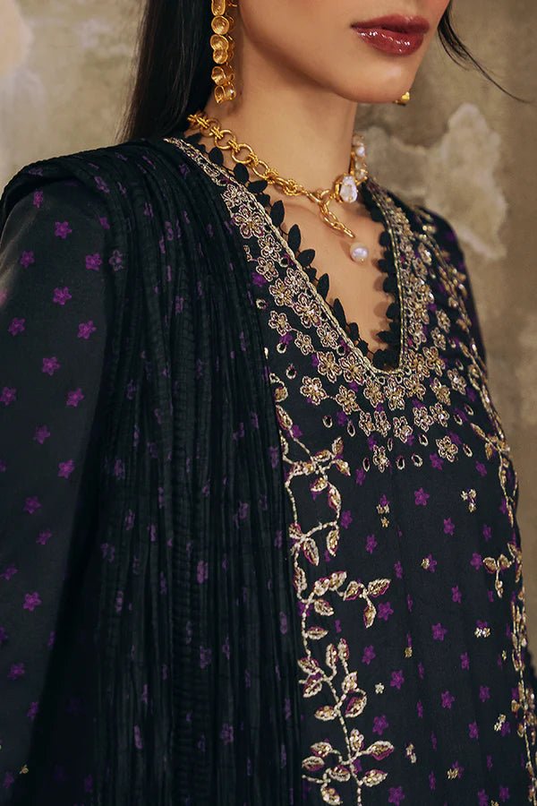 Model wearing Suffuse Silk Pret '24 Layale dress in deep black with intricate gold embroidery. Shop Pakistani bridal dresses online in the UK now.