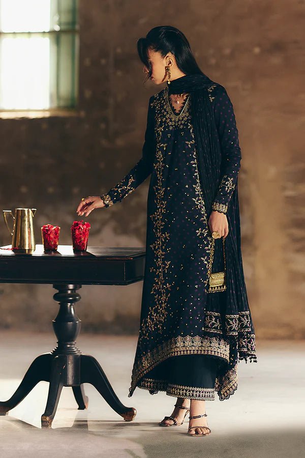 Model wearing Suffuse Silk Pret '24 Layale dress in deep black with intricate gold embroidery. Shop Pakistani bridal dresses online in the UK now.