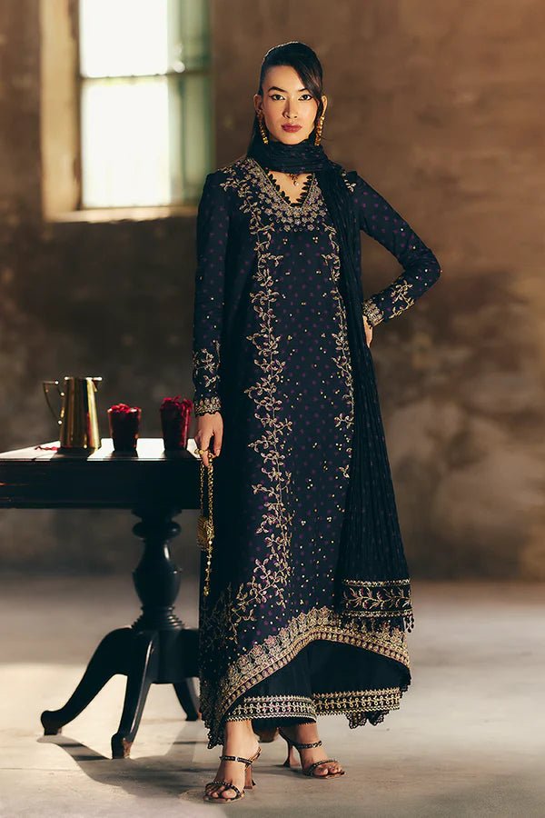 Model wearing Suffuse Silk Pret '24 Layale dress in deep black with intricate gold embroidery. Shop Pakistani bridal dresses online in the UK now.