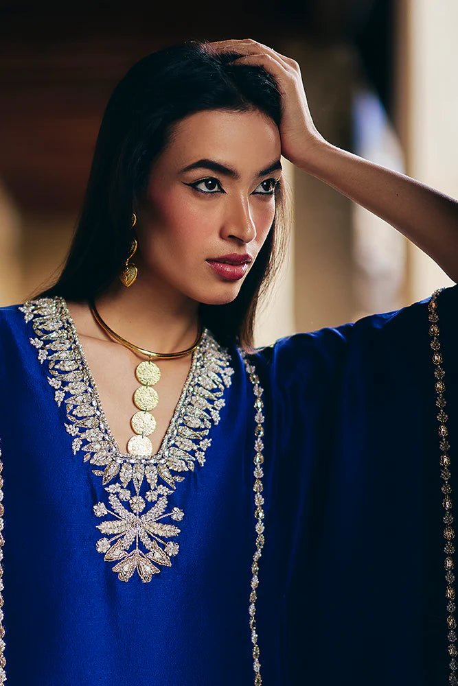 Model wearing Suffuse Silk Pret '24 Navara dress in royal blue with elegant embellishments. Shop Pakistani bridal dresses online in the UK now.