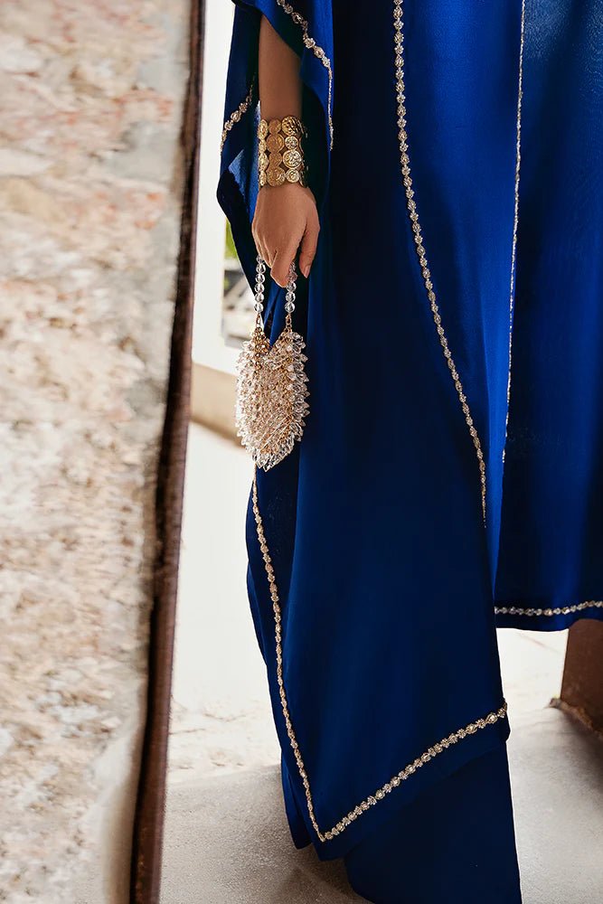 Model wearing Suffuse Silk Pret '24 Navara dress in royal blue with elegant embellishments. Shop Pakistani bridal dresses online in the UK now.