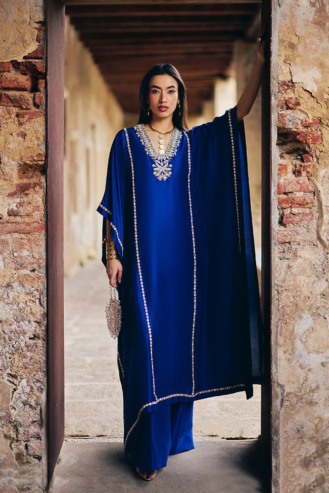 Model wearing Suffuse Silk Pret '24 Navara dress in royal blue with elegant embellishments. Shop Pakistani bridal dresses online in the UK now.