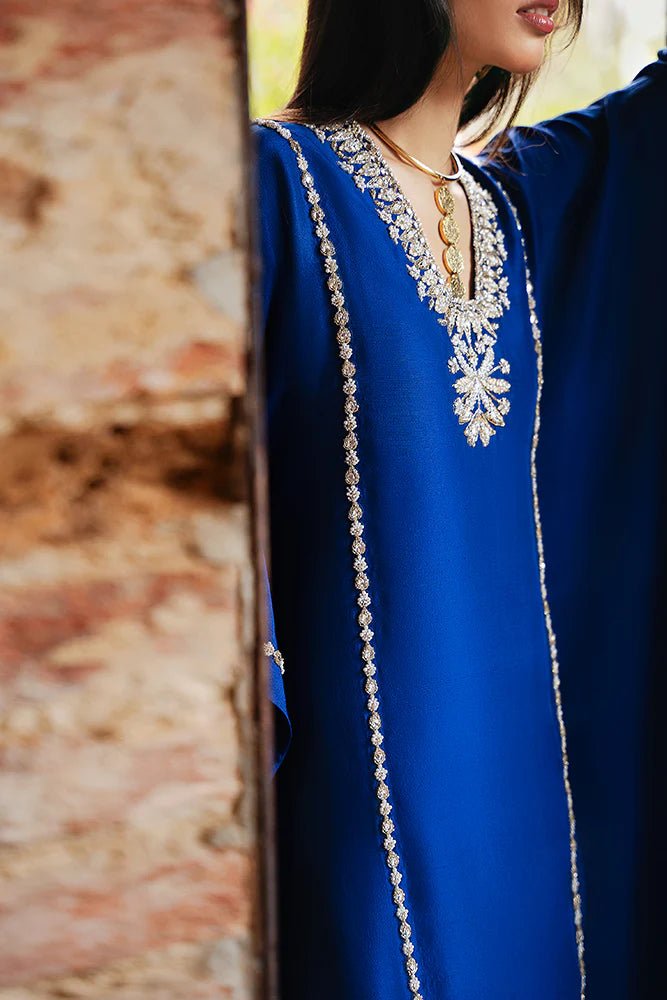 Model wearing Suffuse Silk Pret '24 Navara dress in royal blue with elegant embellishments. Shop Pakistani bridal dresses online in the UK now.