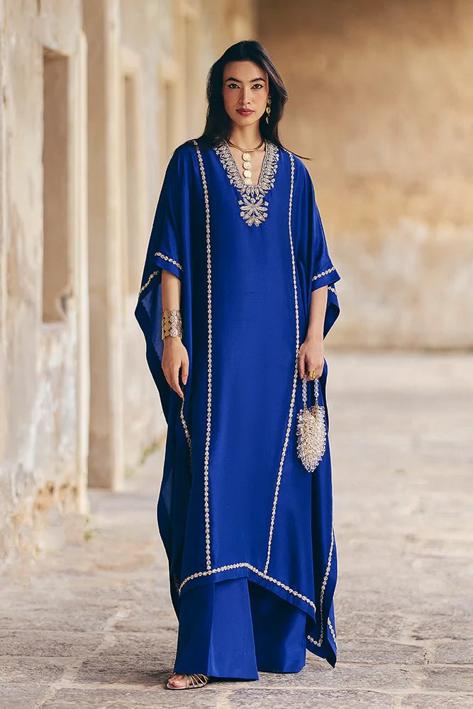 Model wearing Suffuse Silk Pret '24 Navara dress in royal blue with elegant embellishments. Shop Pakistani bridal dresses online in the UK now.