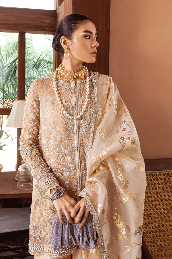 Model wearing Suffuse Marigold dress, a luxurious choice from Luxury Pret Aura collection. Perfect for Pakistani wedding clothes online in UK.