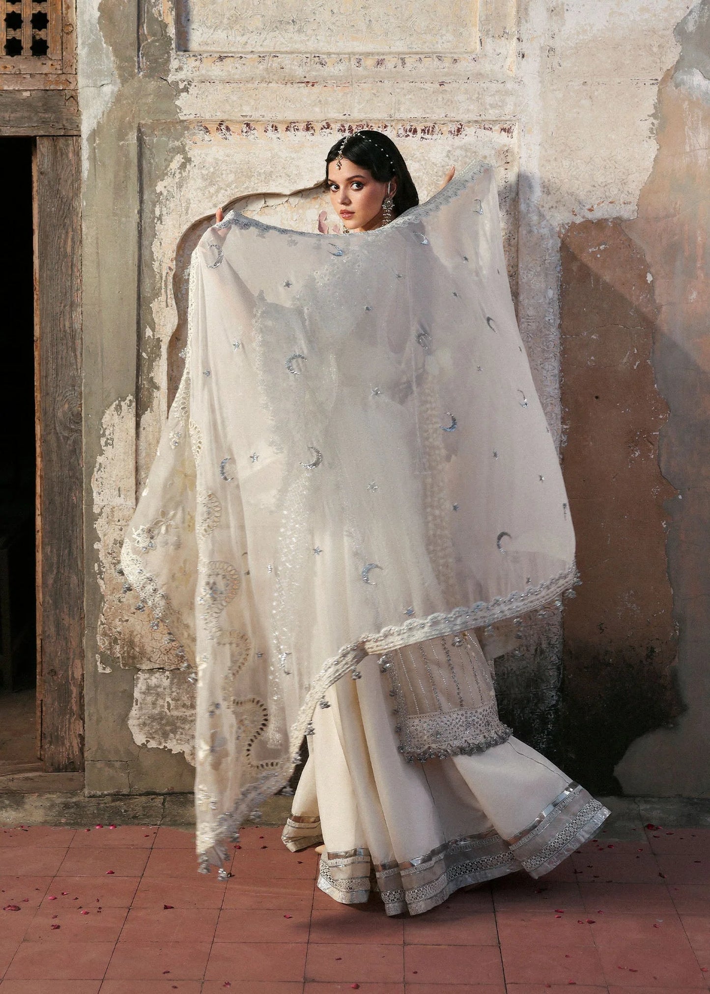 Model wearing Sitara by Hussain Rehar in ivory with silver mirror work – Pakistani luxury pret, shop Hussain Rehar clothes online in UK.

