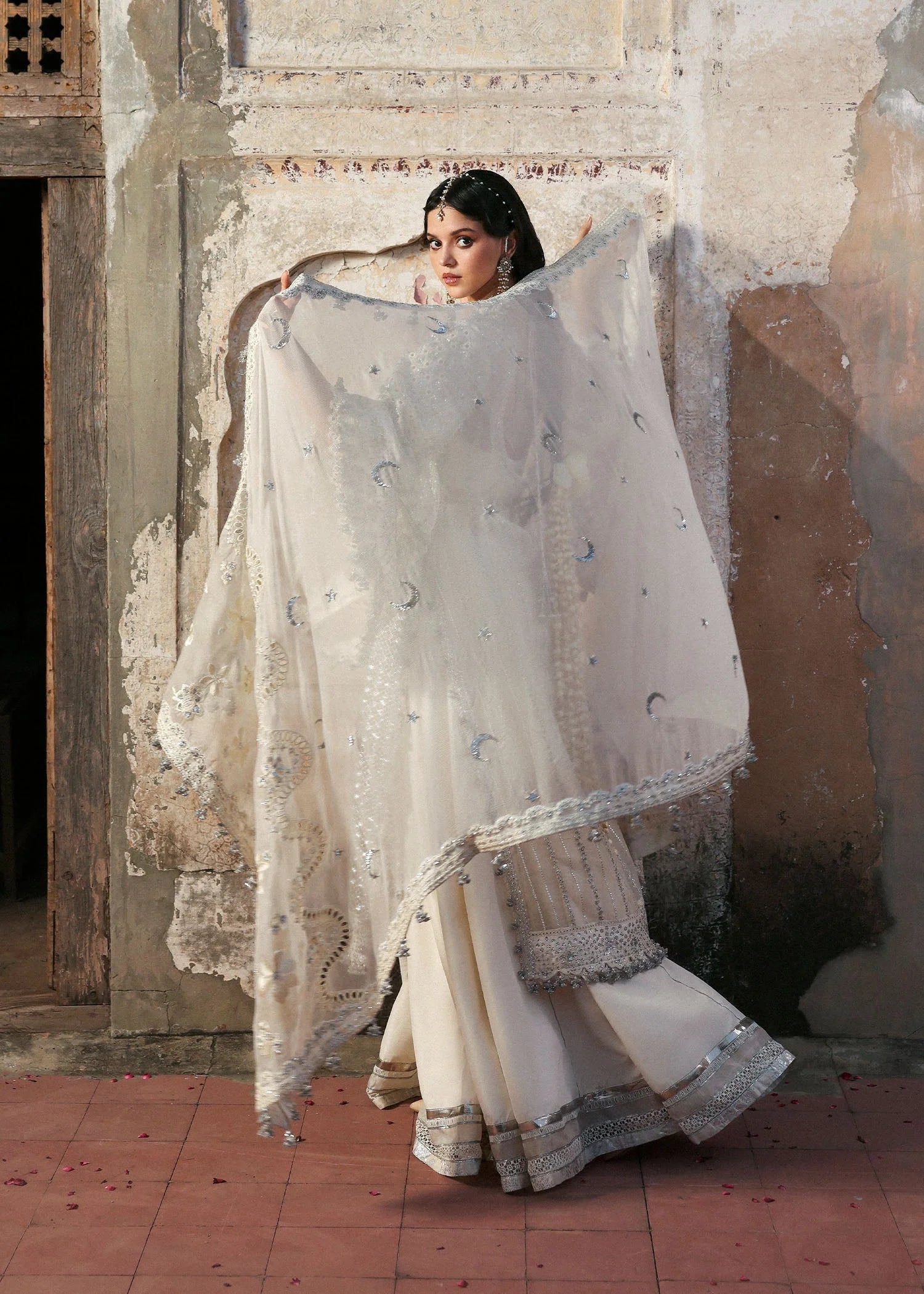 Model wearing Sitara by Hussain Rehar in ivory with silver mirror work – Pakistani luxury pret, shop Hussain Rehar clothes online in UK.
