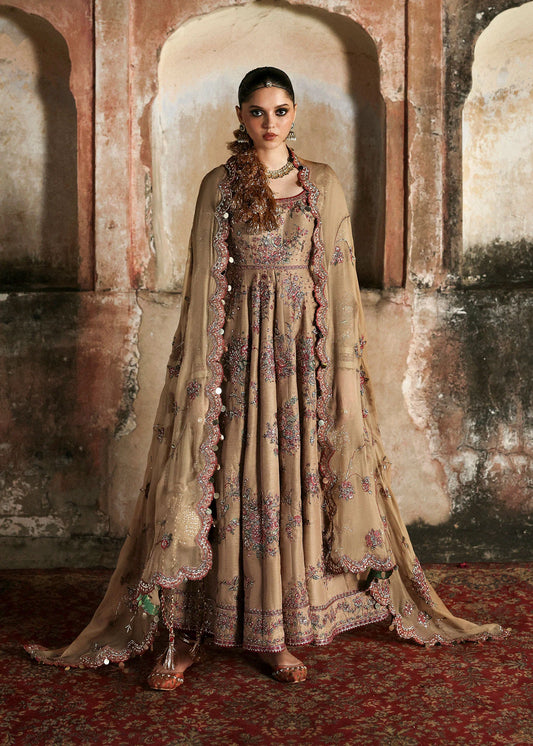 Model wearing Hussain Rehar Mahvash in beige, a heavily embroidered Pakistani luxury pret dress, available online in the UK.