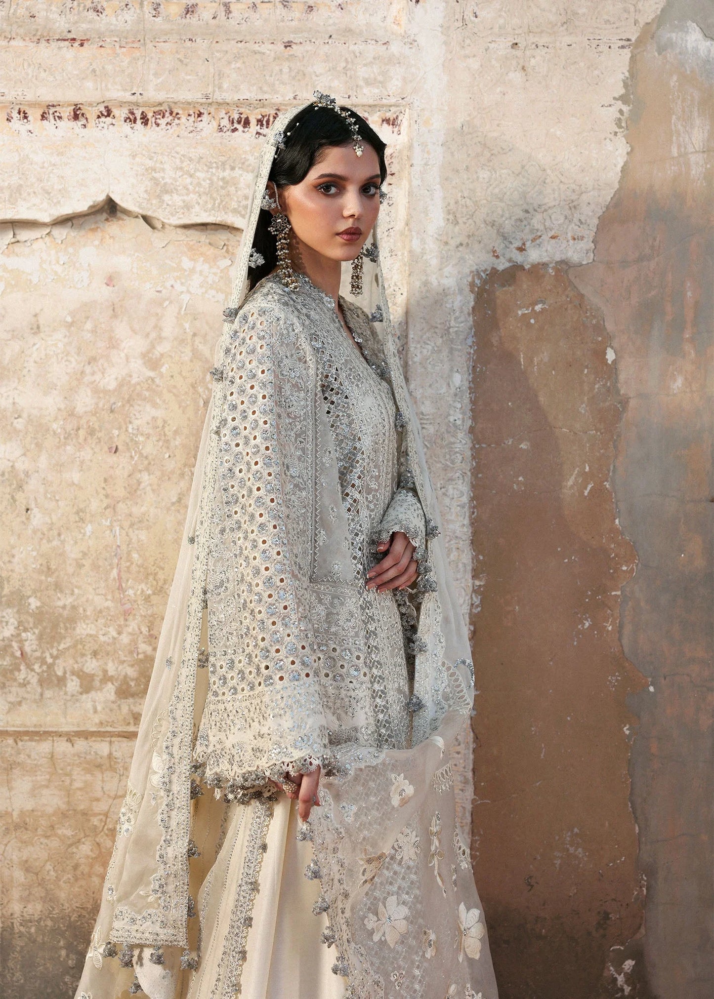 Model wearing Sitara by Hussain Rehar in ivory with silver mirror work – Pakistani luxury pret, shop Hussain Rehar clothes online in UK.

