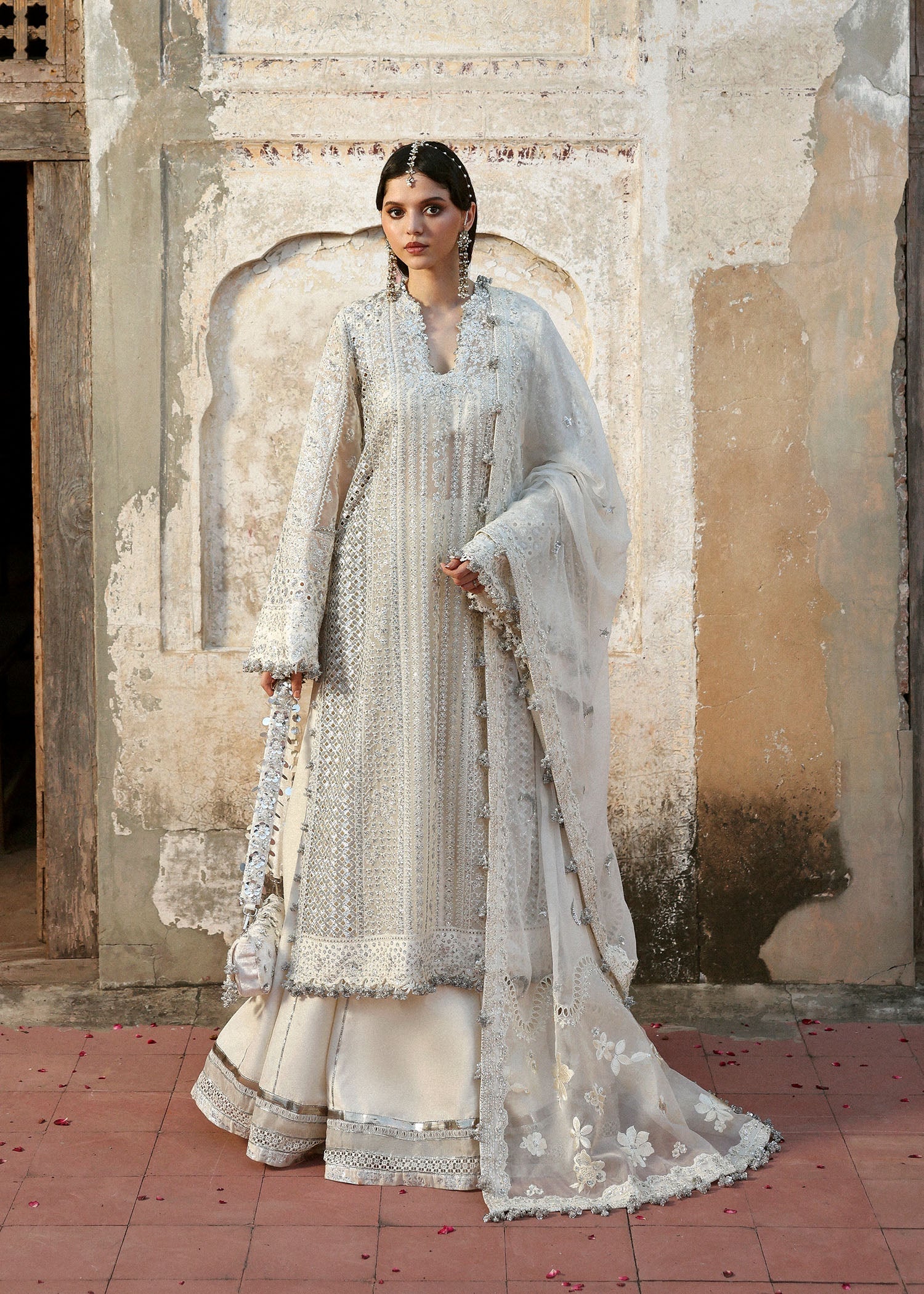 Model wearing Sitara by Hussain Rehar in ivory with silver mirror work – Pakistani luxury pret, shop Hussain Rehar clothes online in UK.
