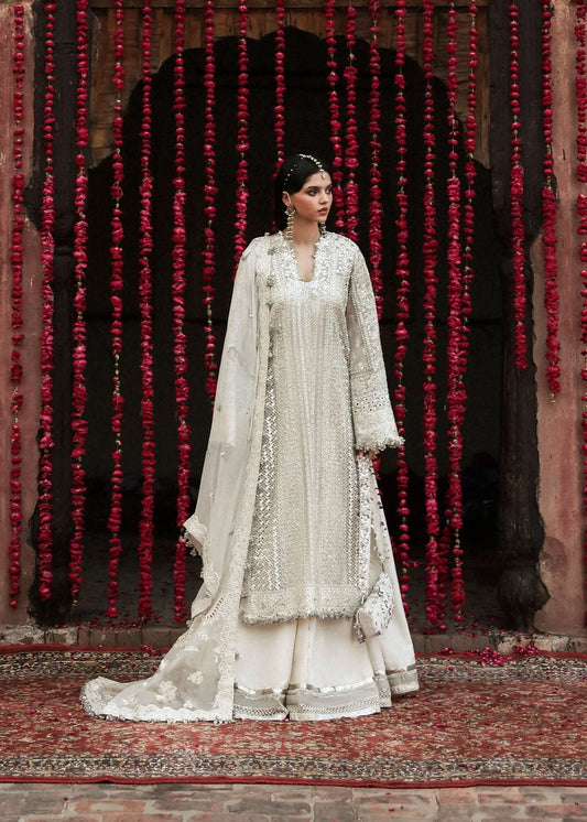 Model wearing Sitara by Hussain Rehar in ivory with silver mirror work – Pakistani luxury pret, shop Hussain Rehar clothes online in UK.
