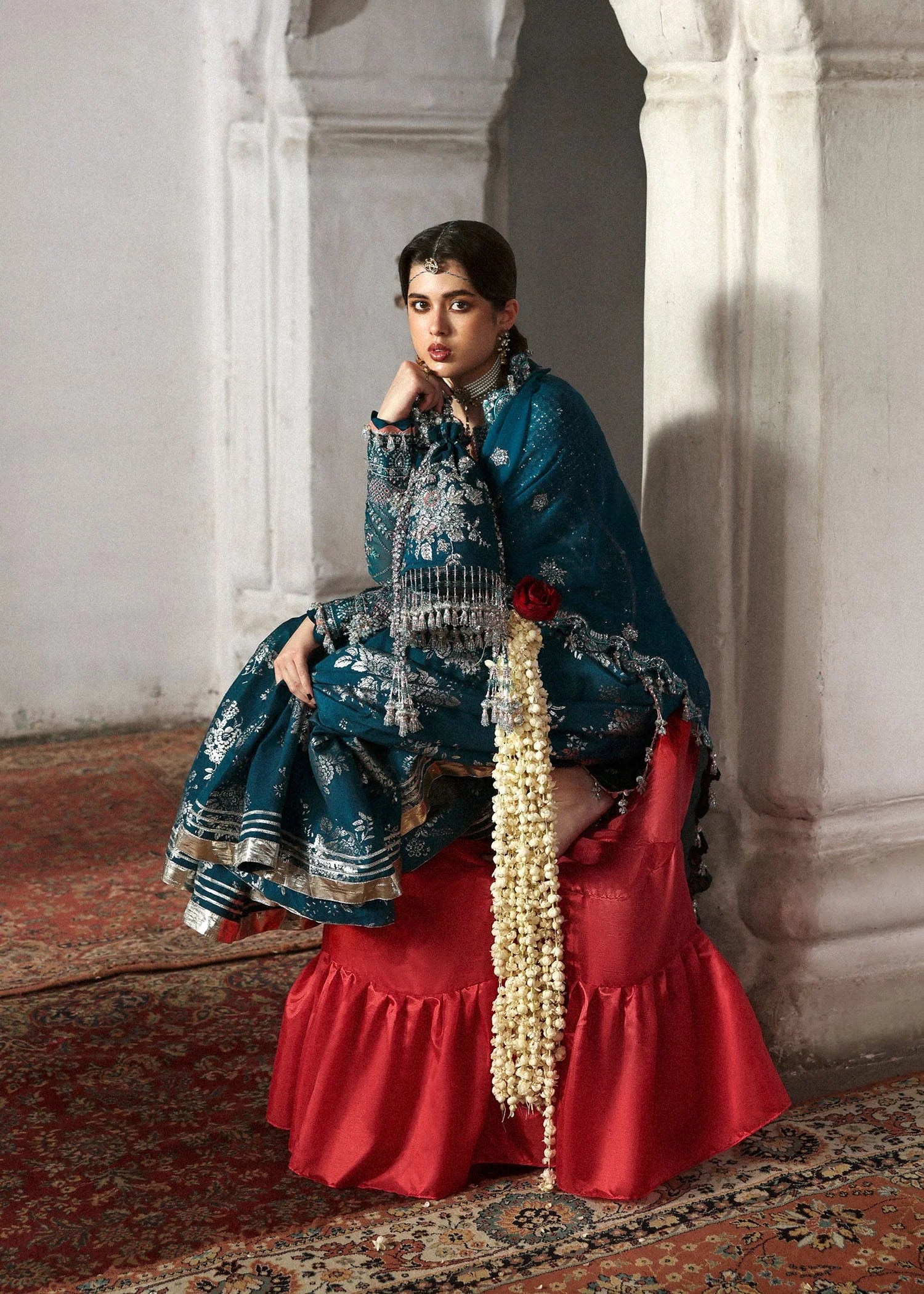 Model wearing deep teal Zebunisa by Hussain Rehar with intricate silver embroidery – Pakistani luxury pret, shop online in UK.
