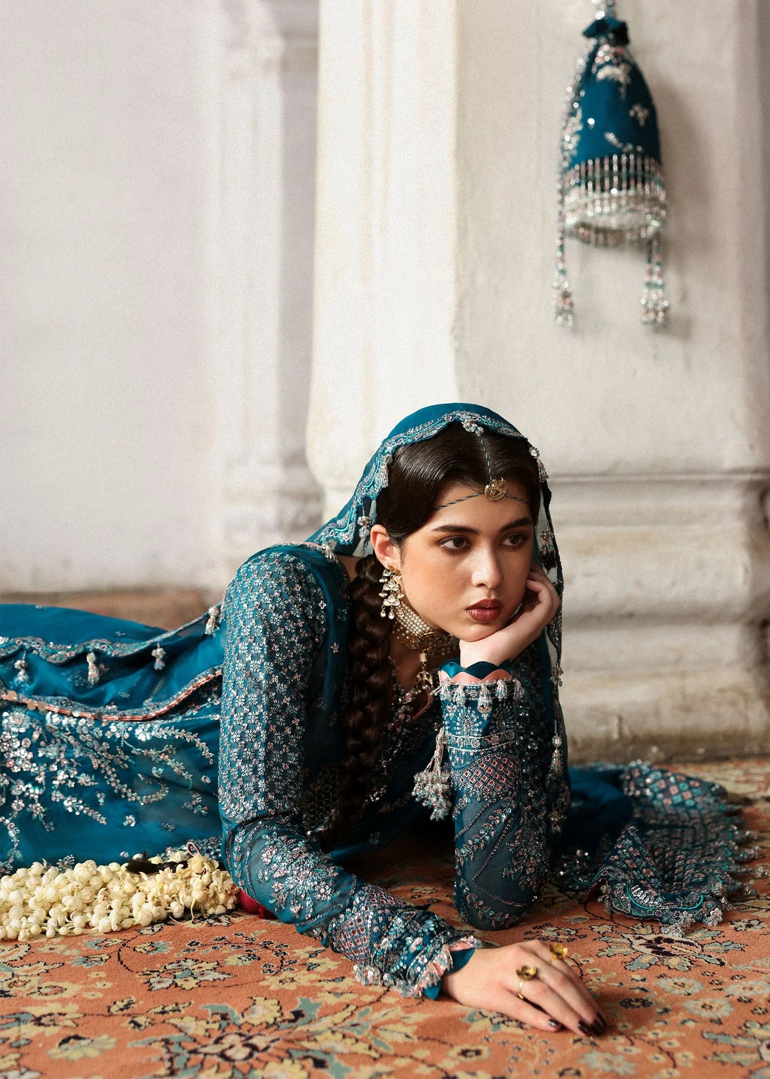Model wearing deep teal Zebunisa by Hussain Rehar with intricate silver embroidery – Pakistani luxury pret, shop online in UK.
