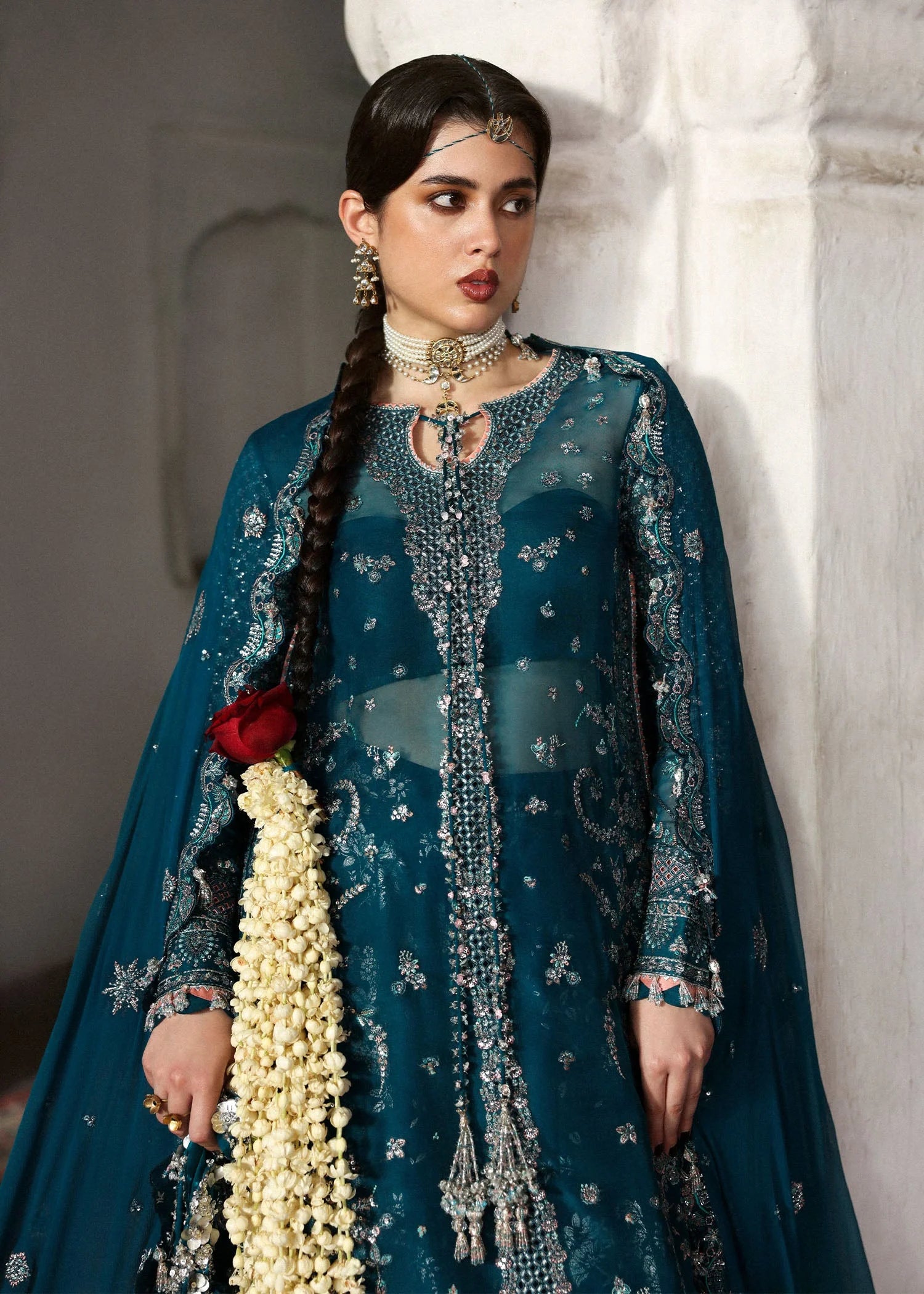 Model wearing deep teal Zebunisa by Hussain Rehar with intricate silver embroidery – Pakistani luxury pret, shop online in UK.
