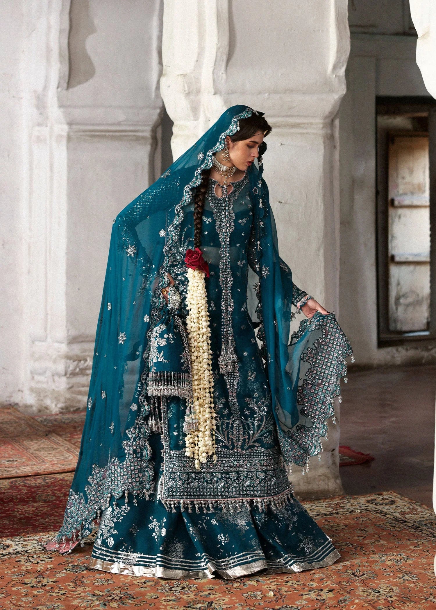 Model wearing deep teal Zebunisa by Hussain Rehar with intricate silver embroidery – Pakistani luxury pret, shop online in UK.

