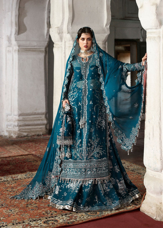 Model wearing deep teal Zebunisa by Hussain Rehar with intricate silver embroidery – Pakistani luxury pret, shop online in UK.
