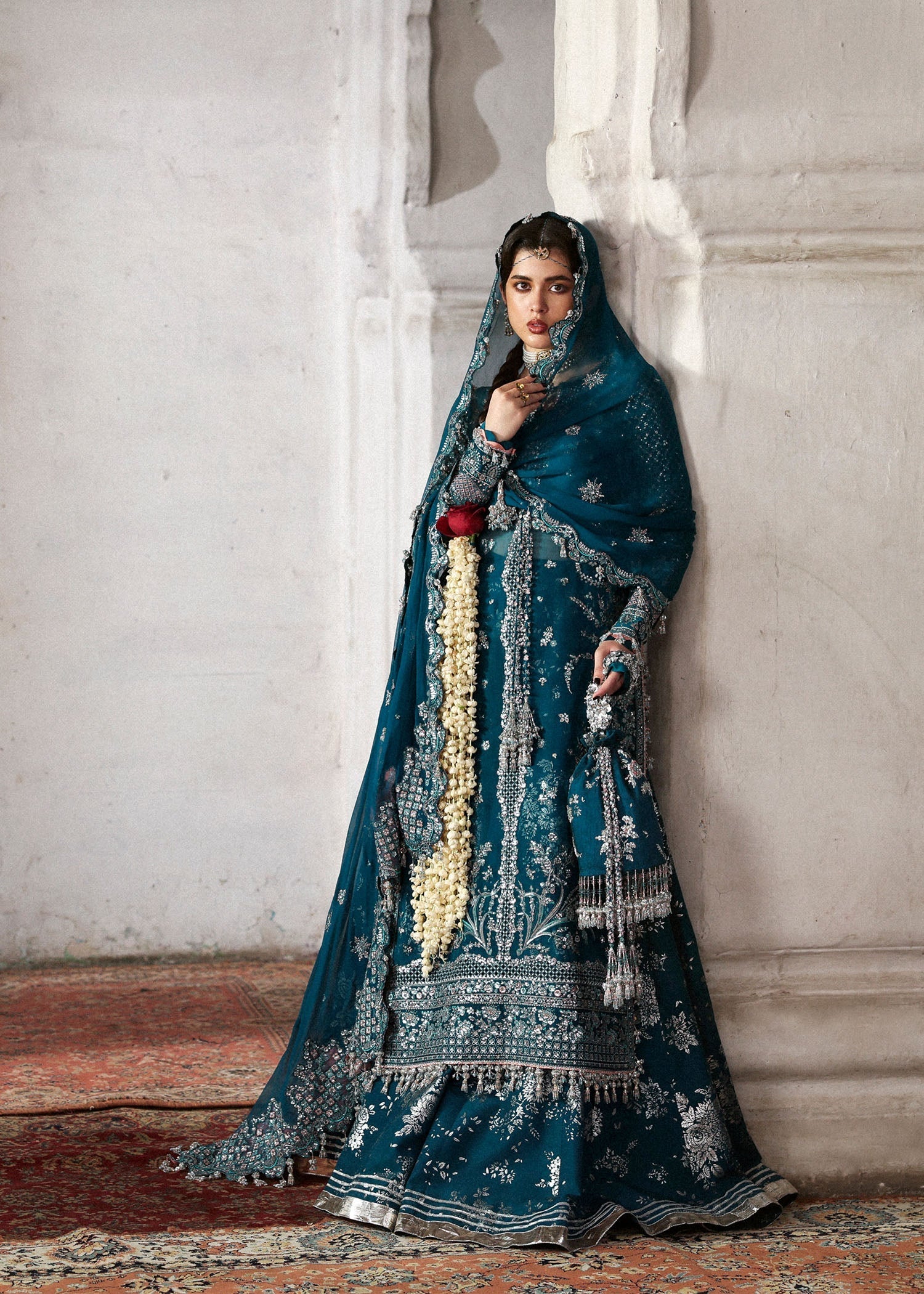 Model wearing deep teal Zebunisa by Hussain Rehar with intricate silver embroidery – Pakistani luxury pret, shop online in UK.
