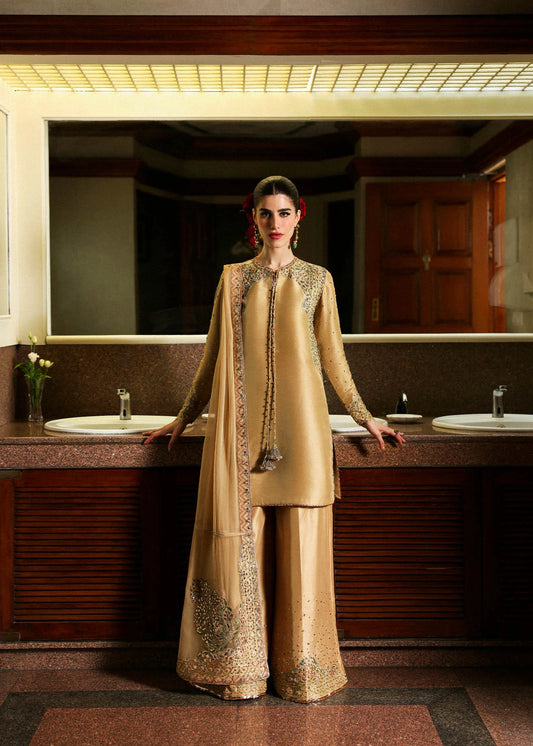 Model wearing gold Delune dress by Hussain Rehar, Pakistani luxury pret available online in UK for festive and wedding wear