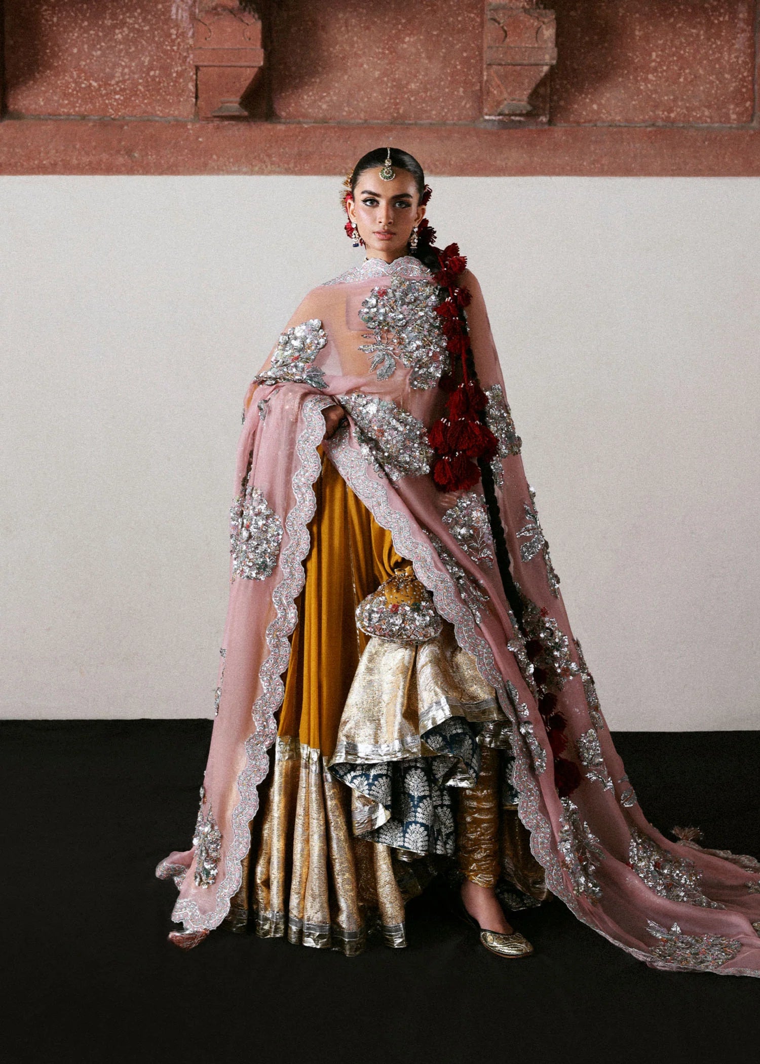Model wearing Elika by Hussain Rehar in mustard and pink with heavy silver embellishments – exquisite Pakistani luxury pret outfit in UK.
