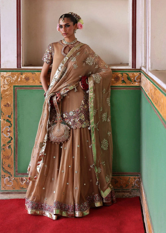 Model wearing Mehrab by Hussain Rehar in bronze with green and pink embroidery – opulent Pakistani luxury pret outfit in UK.