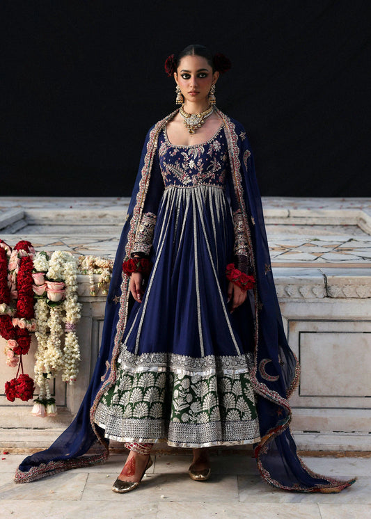 Model wearing Zarmina by Hussain Rehar in navy blue with intricate embroidery and green accents – elegant Pakistani luxury pret outfit in UK.
