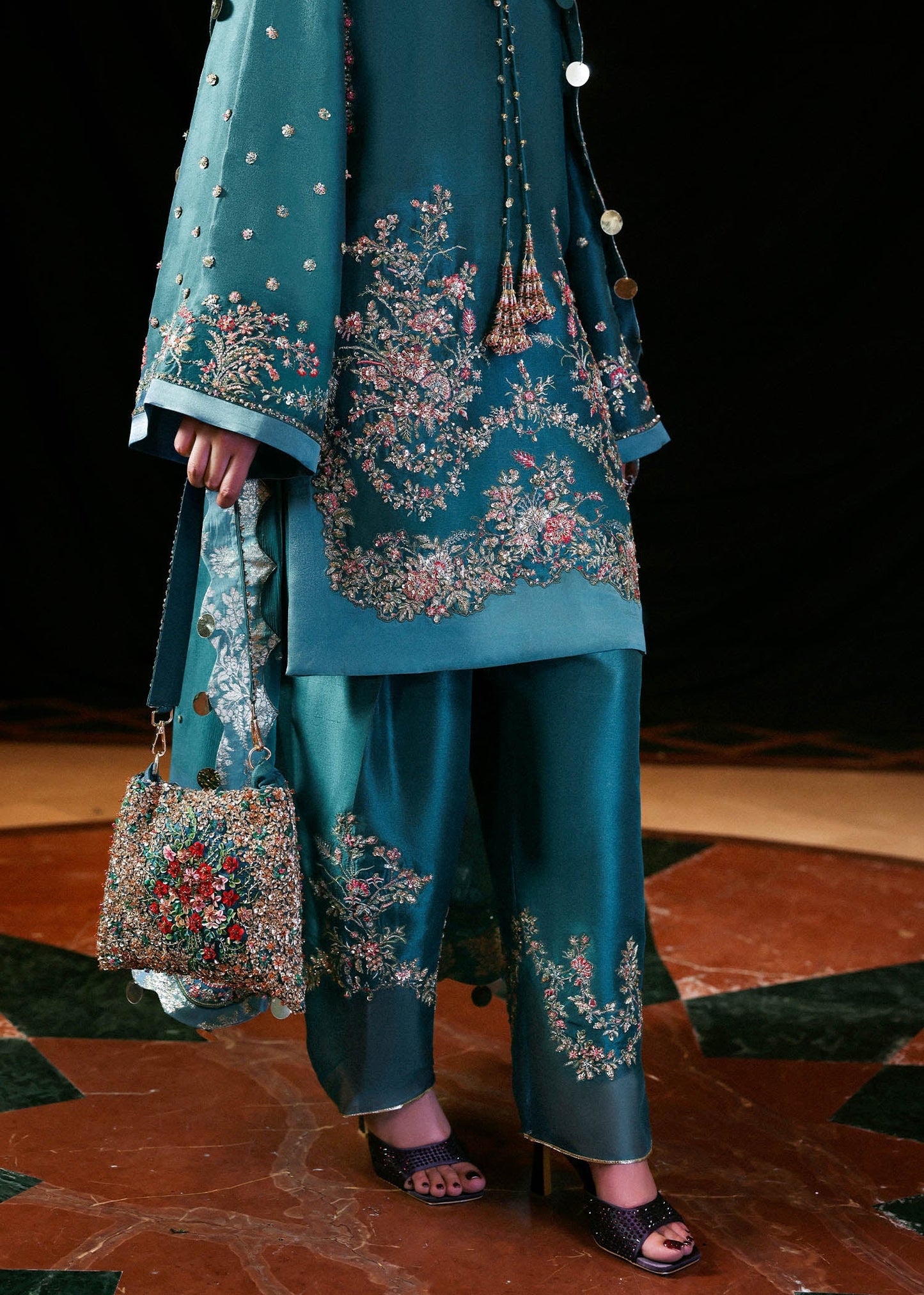 Model wearing teal blue Verta dress by Hussain Rehar, Pakistani luxury pret available online in UK for celebrations and events.
